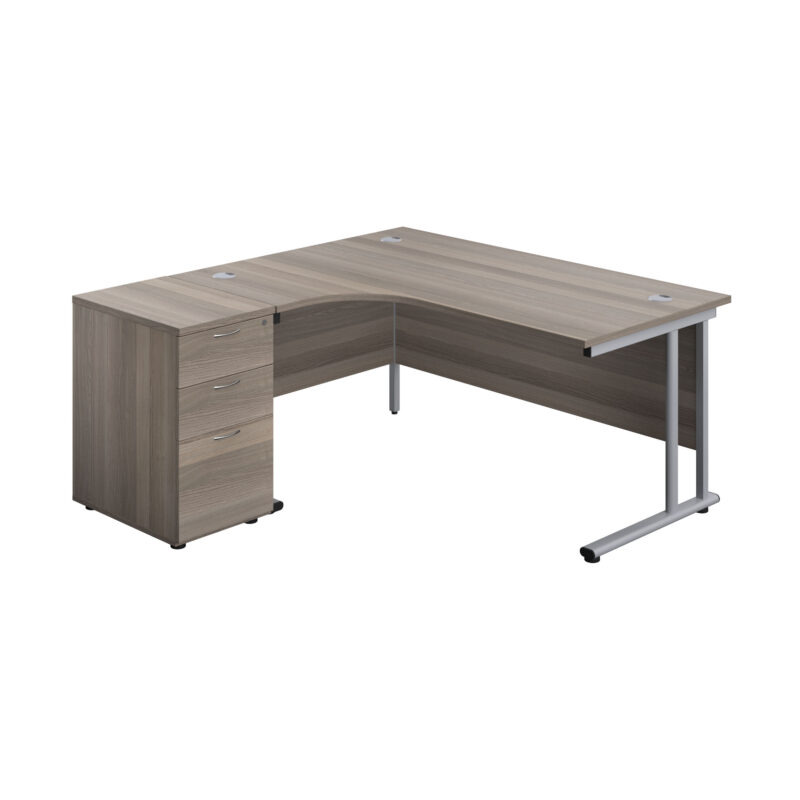 Twin Upright Left Hand Radial Desk + Desk High 3 Drawer Pedestal | 1600X1200 | 600mm Deep Pedestal | Grey Oak/Silver